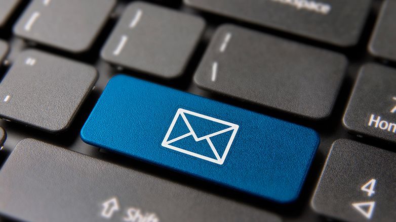A close-up of a keyboard with a blue key displaying a white envelope icon, representing email.